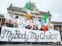 Abortion rights supporters hold signs to repeal Ireland's 8th amendment